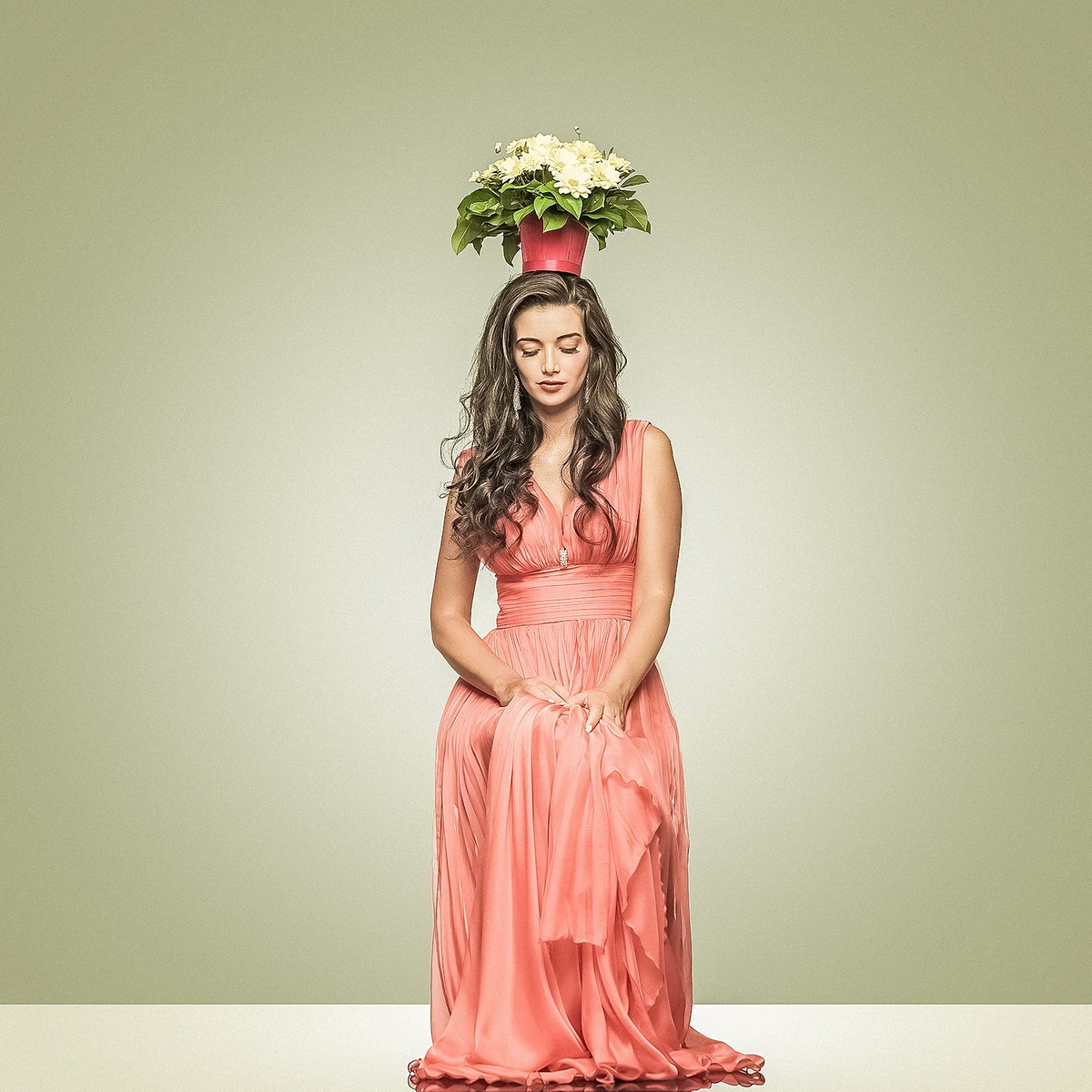 Young beautiful woman in long elegant red dress and flowers